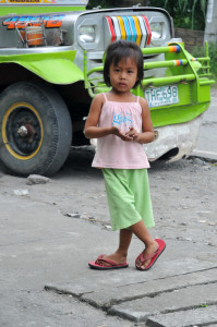 Philippines, Mindanao, Girl in front of jeepney